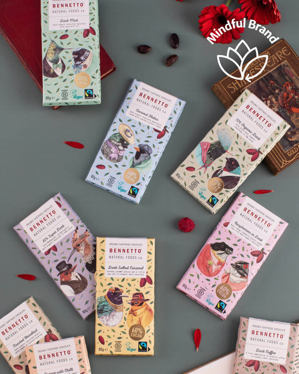 Various chocolate bars with packaging on a gray surface, featuring the Bennetto brand.