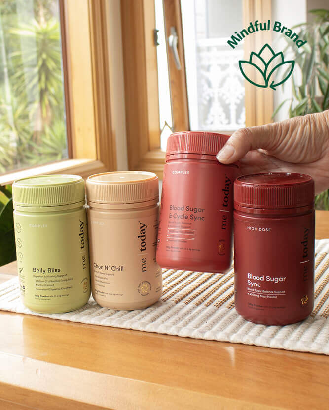 Four supplement containers on a wooden surface with a 'Mindful Brand' logo in the corner.