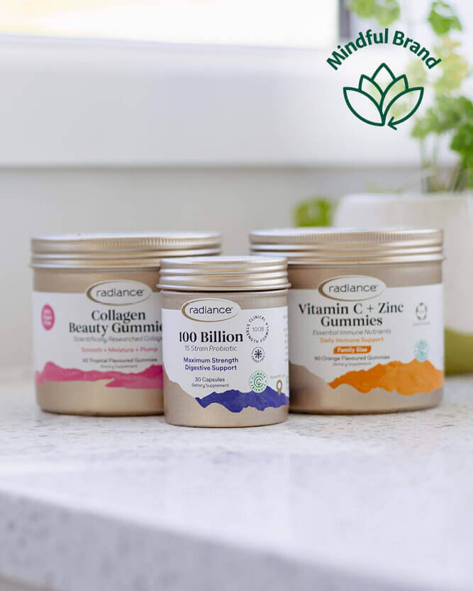 Three containers of Radiance gummies on a white surface with a blurred background.