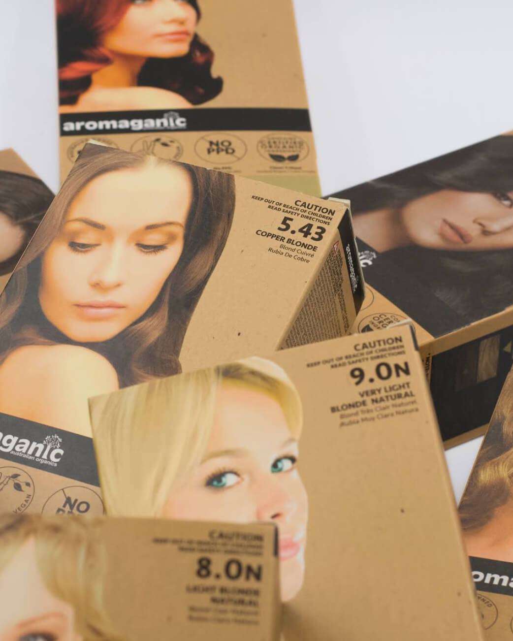 Collection of hair colour boxes with images of women on a white background