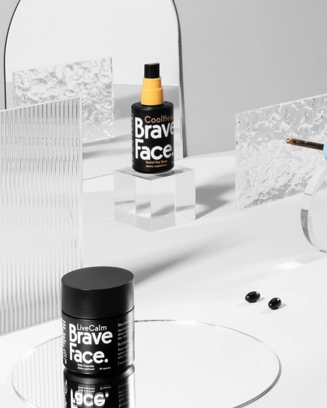 Brave Face skincare products on a bathroom counter with a mirror in the background