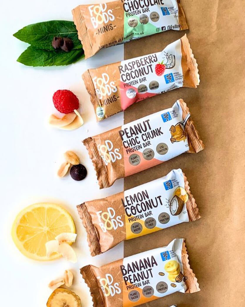 Assorted protein bars with visible flavors on a brown background.