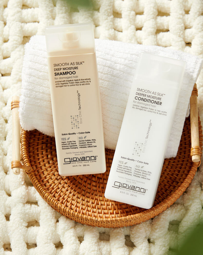 Giovanni shampoo and conditioner bottles in a woven basket.