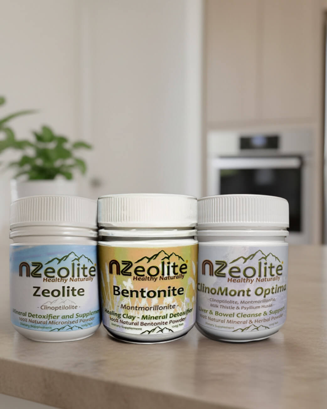 Three jars of NZeolite products on a kitchen counter.
