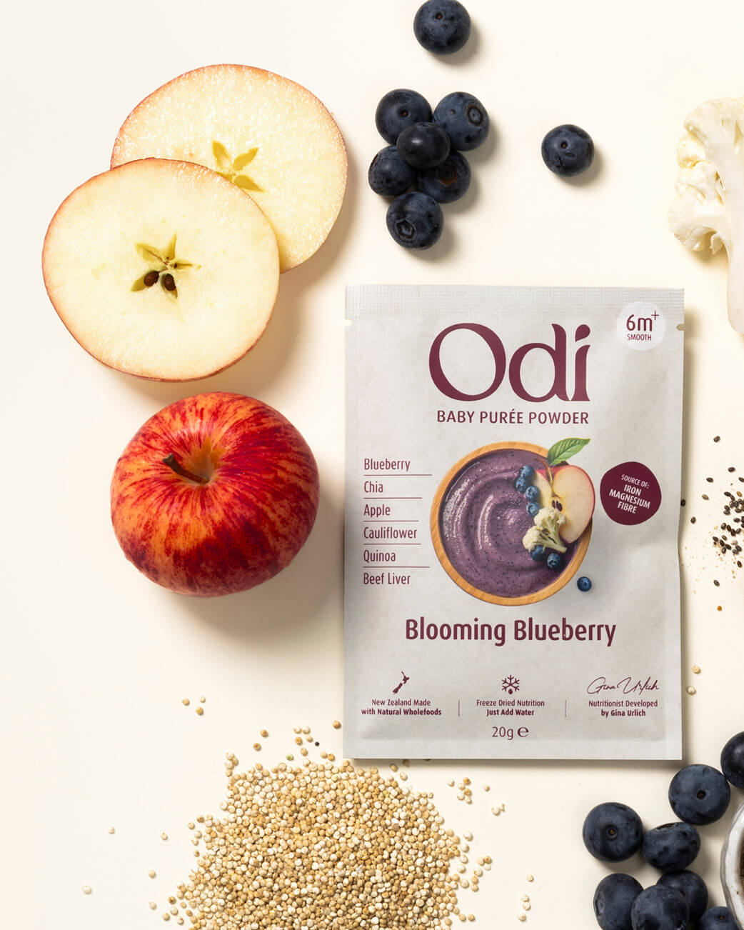 Odi baby puree powder package with apples, blueberries, and other ingredients on a white background.