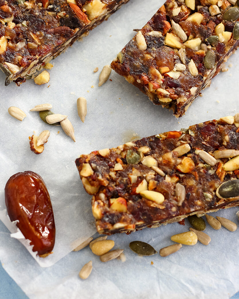 Nut and seed bars with a date on a marble surface