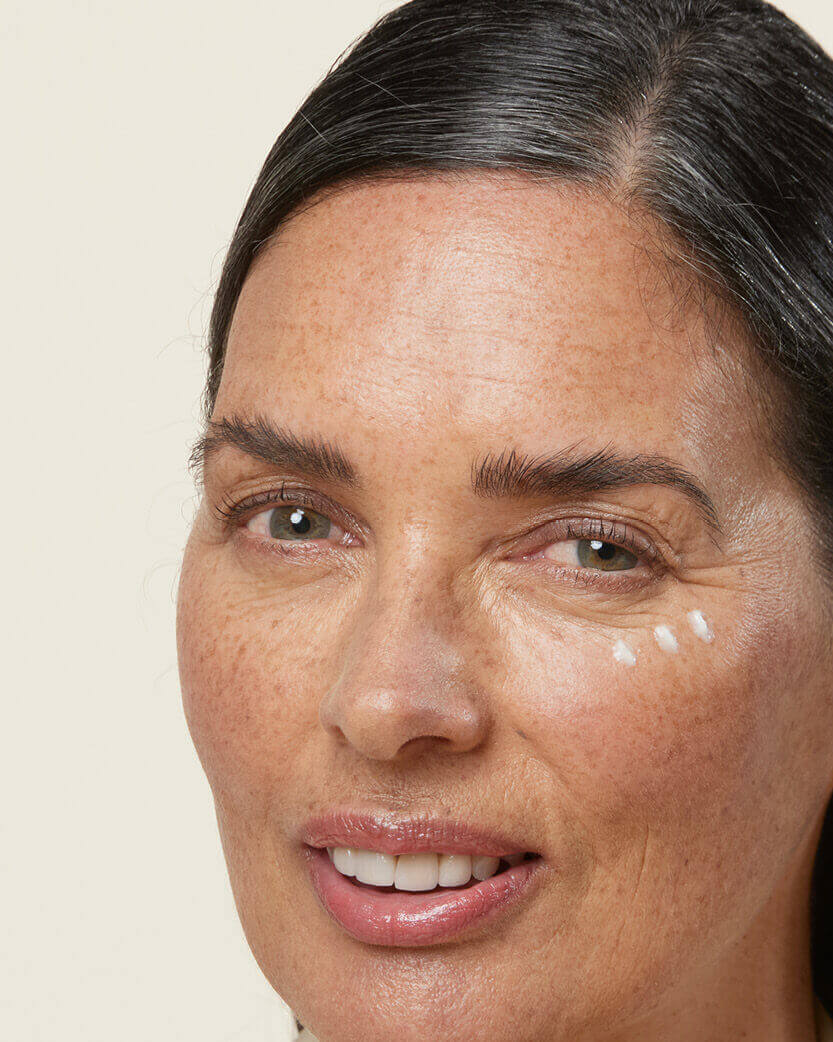 Close-up of a woman's face with a neutral background.