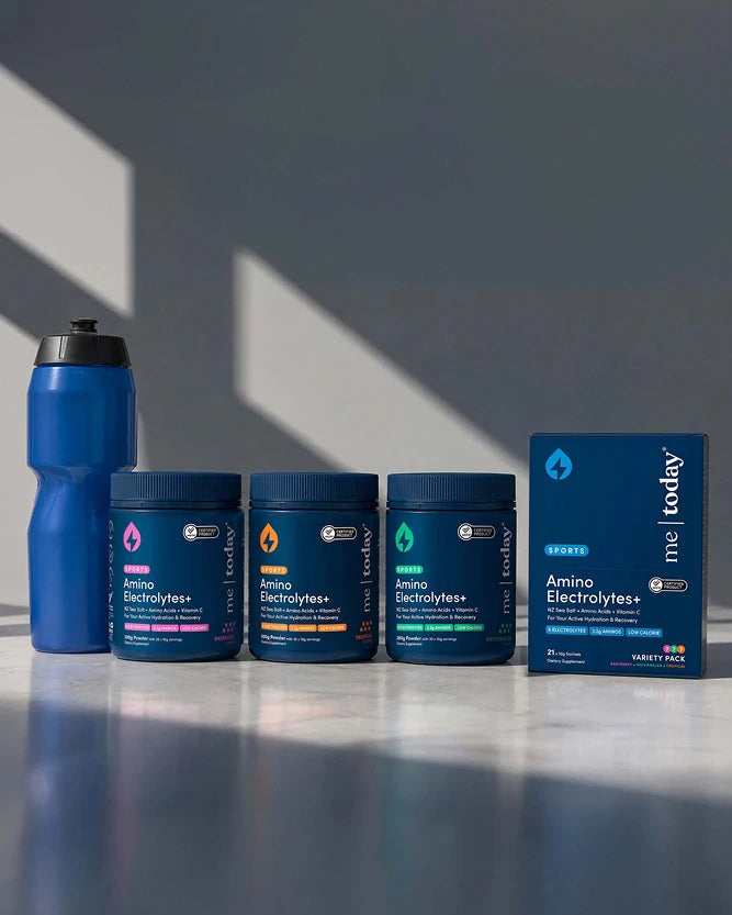 Me Today Amino Electrolyte+ range lined up on a kitchen surface with a drink bottle.