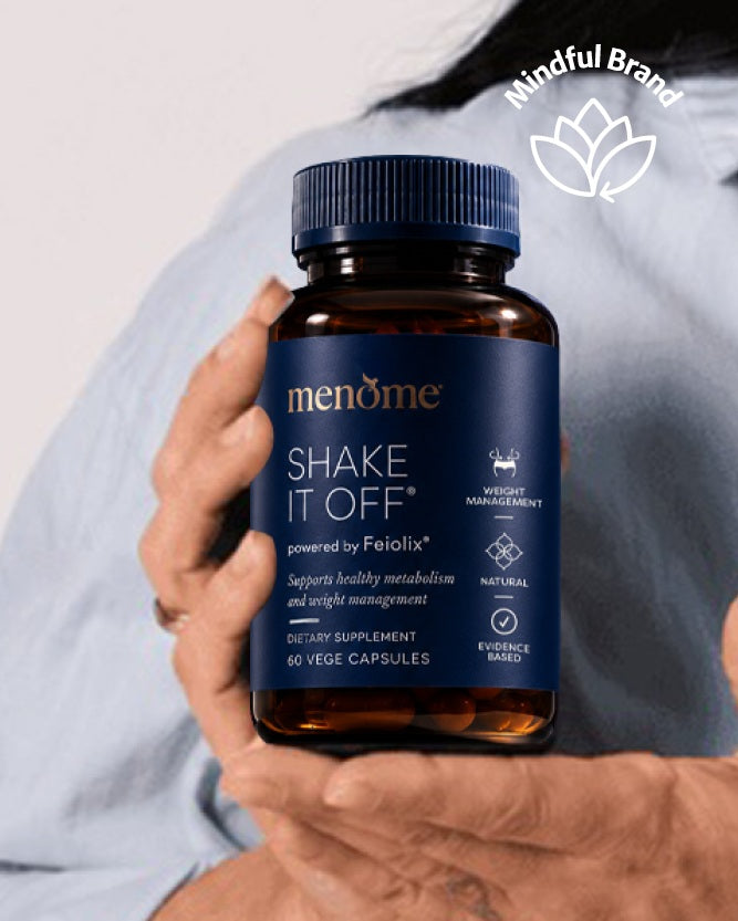 Person holding MenoMe bottle of Shake it Off with white mindful brand logo.
