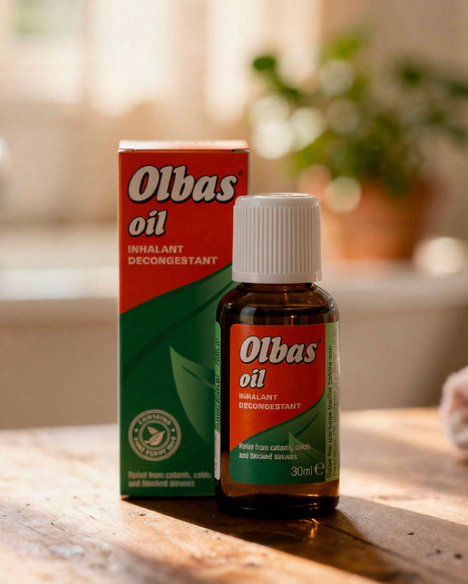 Olbas oil inhalant decongestant bottle and packaging on a wooden surface with a blurred background