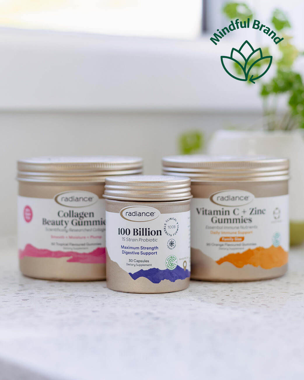 Three containers of Radiance gummies on a white surface with a blurred background.