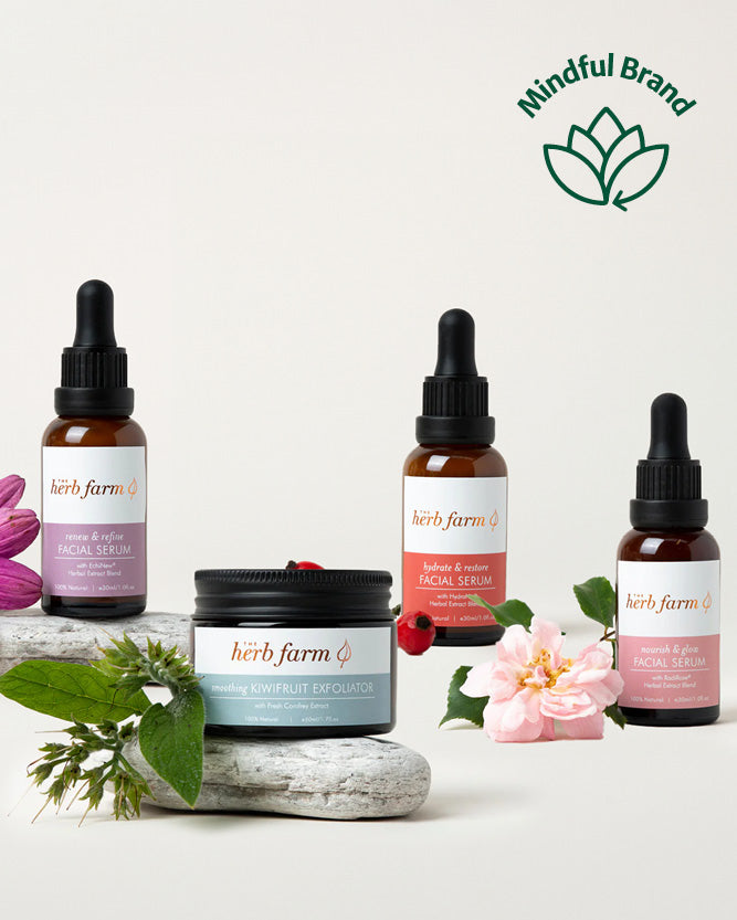 Herb farm skincare products with droppers and a jar on a light background, featuring the Mindful Brand logo.