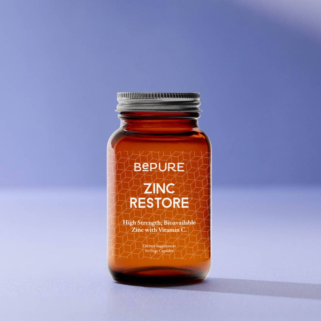 BePure Zinc Restore supplement bottle on a gradient blue background