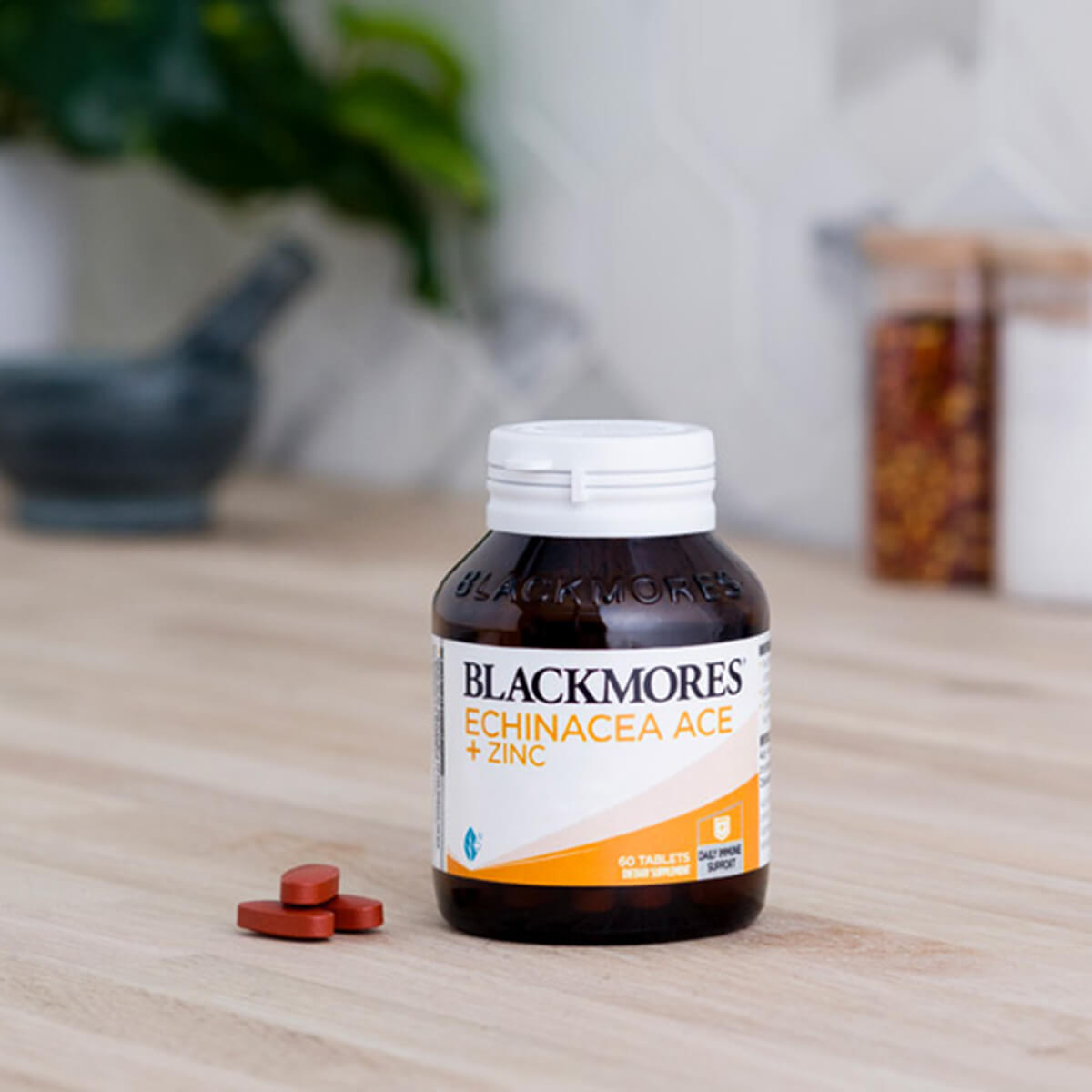 Blackmores Echinacea ACE + Zinc supplement bottle on a wooden surface with tablets.