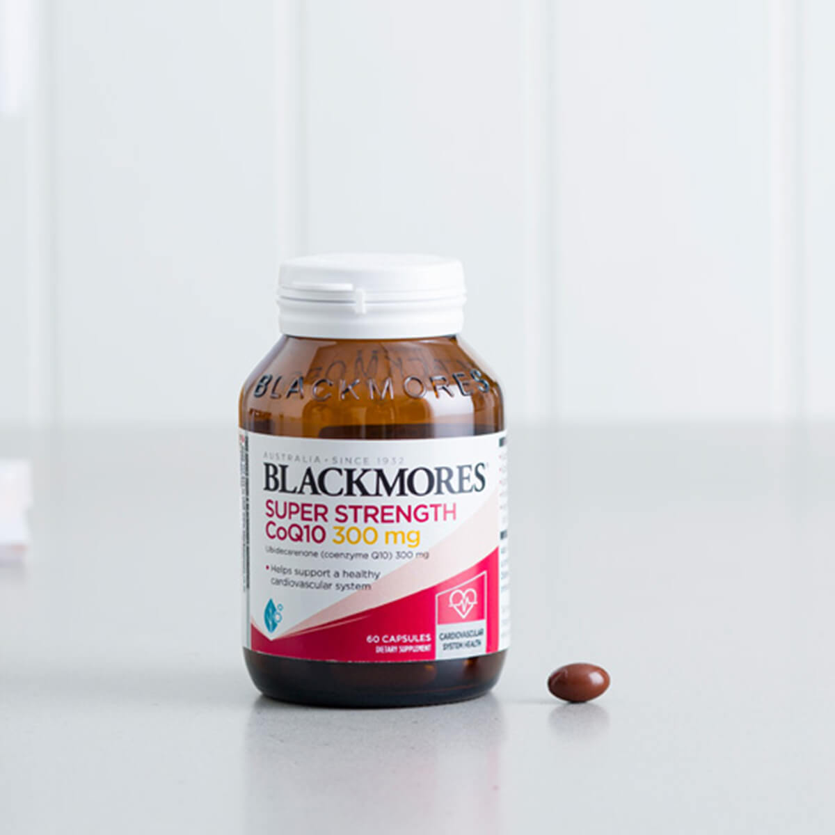 Blackmores Super Strength CoQ10 supplement bottle on a white surface.