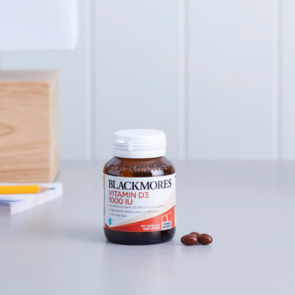 Blackmores Vitamin D3 1000IU supplement bottle on a white surface.