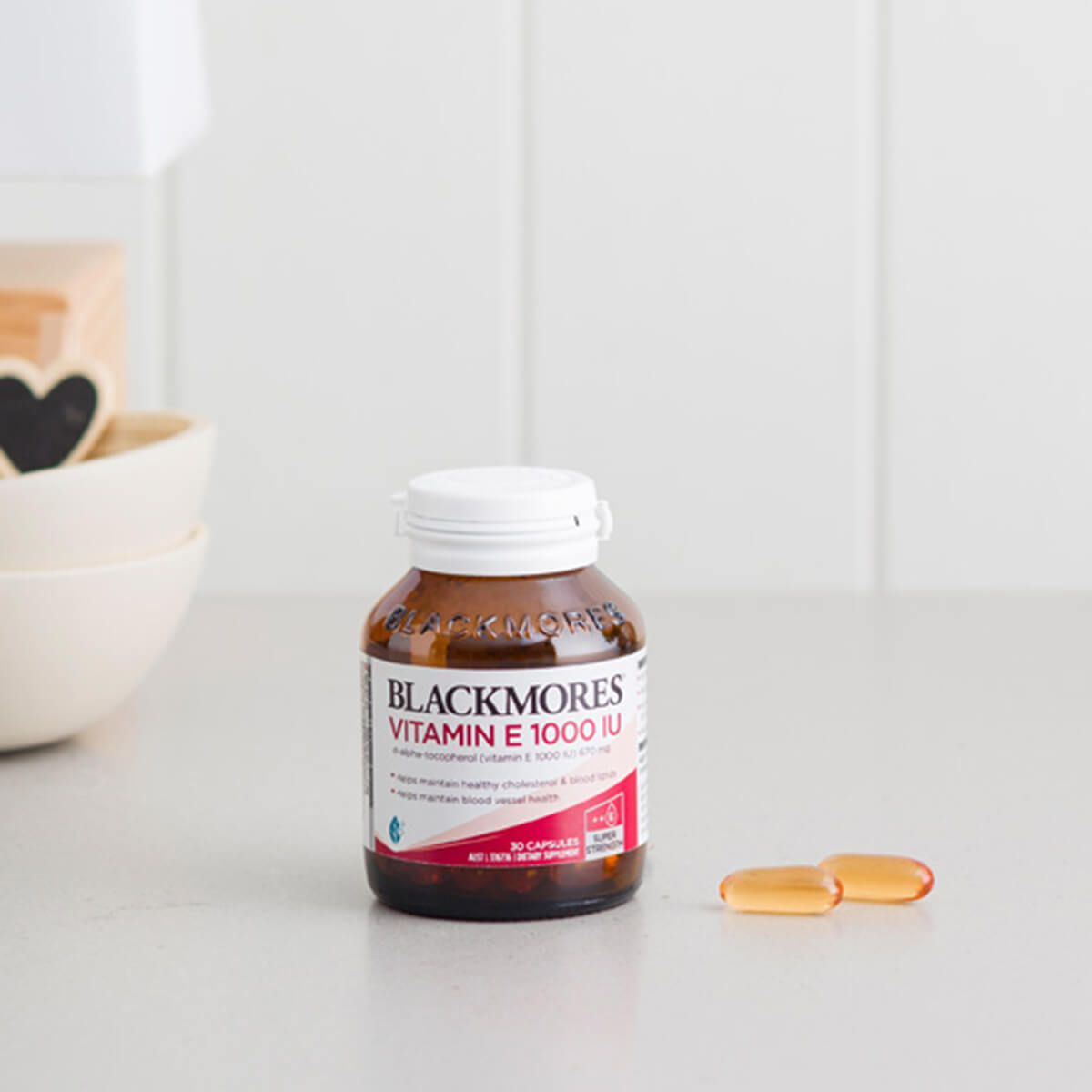 Blackmores Vitamin E 1000 IU bottle on a white surface with a white background.