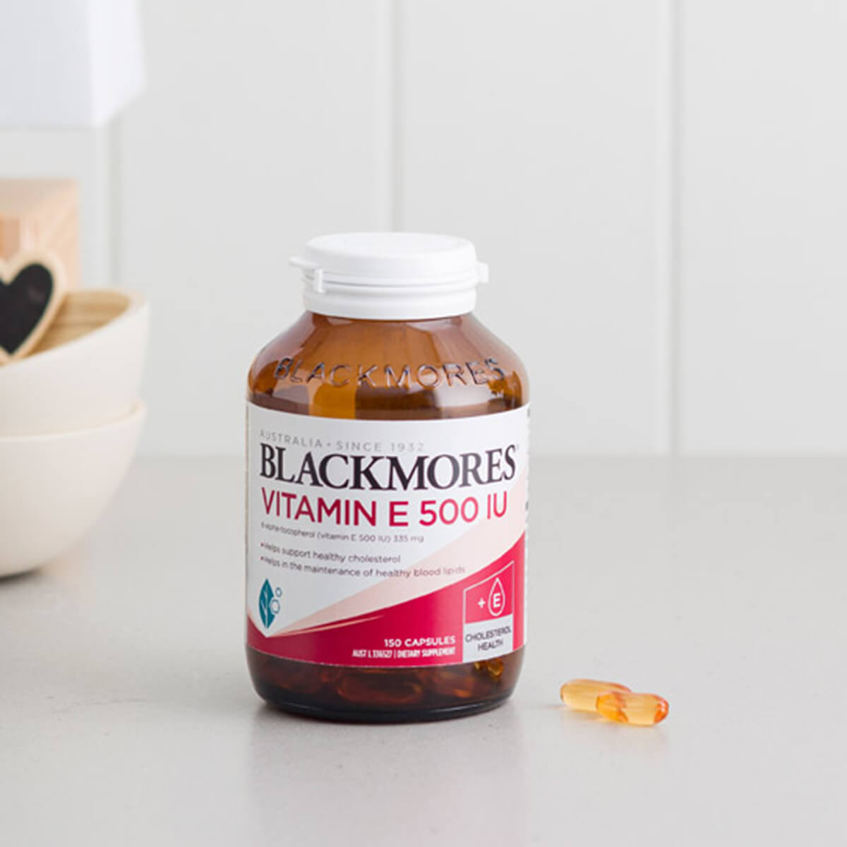 Blackmores Vitamin E 500 IU supplement bottle on a white surface.