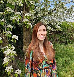 Woman standing in a garden with blooming trees