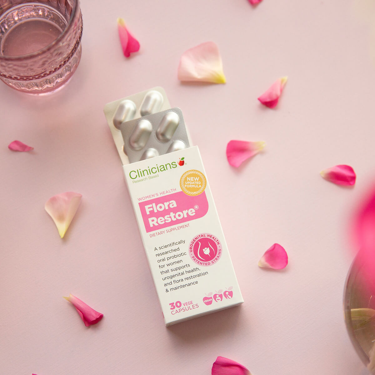 Clinicians Flora Restore product packaging on a pink background with flower petals.