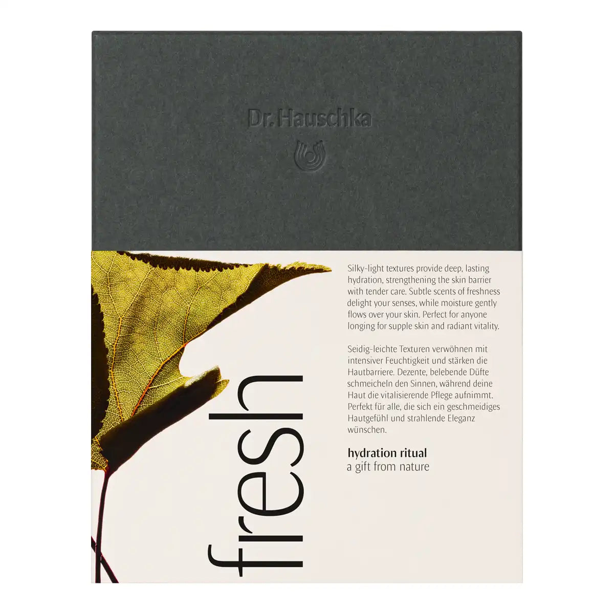 Dr. Hauschka Fresh Gift Set, featuring a dark gray top section with the brand name and a lower cream-colored section with text and a leaf graphic.