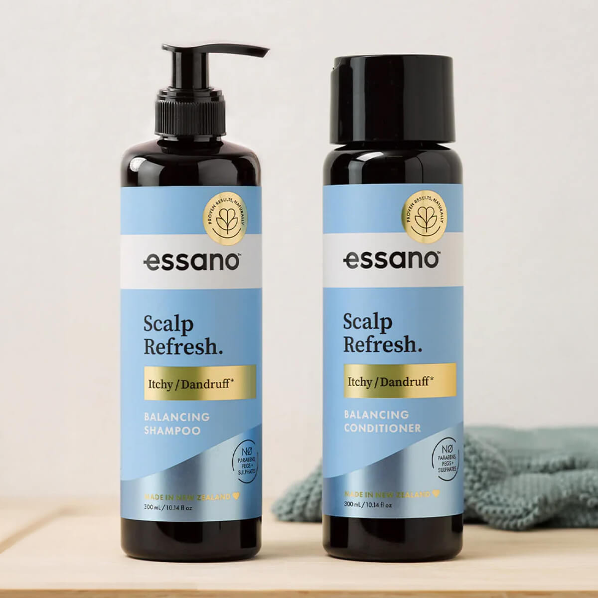Two bottles of essano Scalp Refresh shampoo and conditioner on a light background.