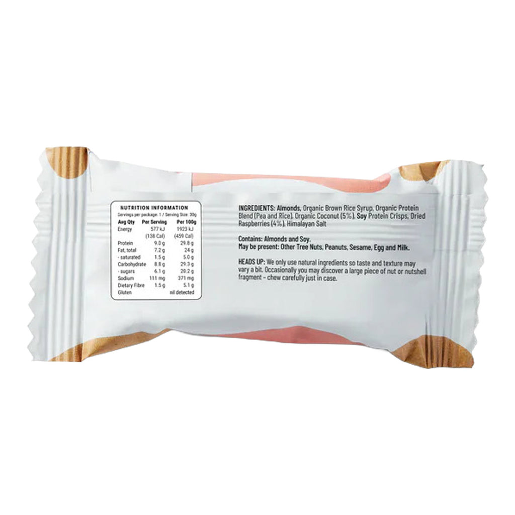 Back of raspberry coconut protein bar with a white wrapper displaying nutritional information on a white background