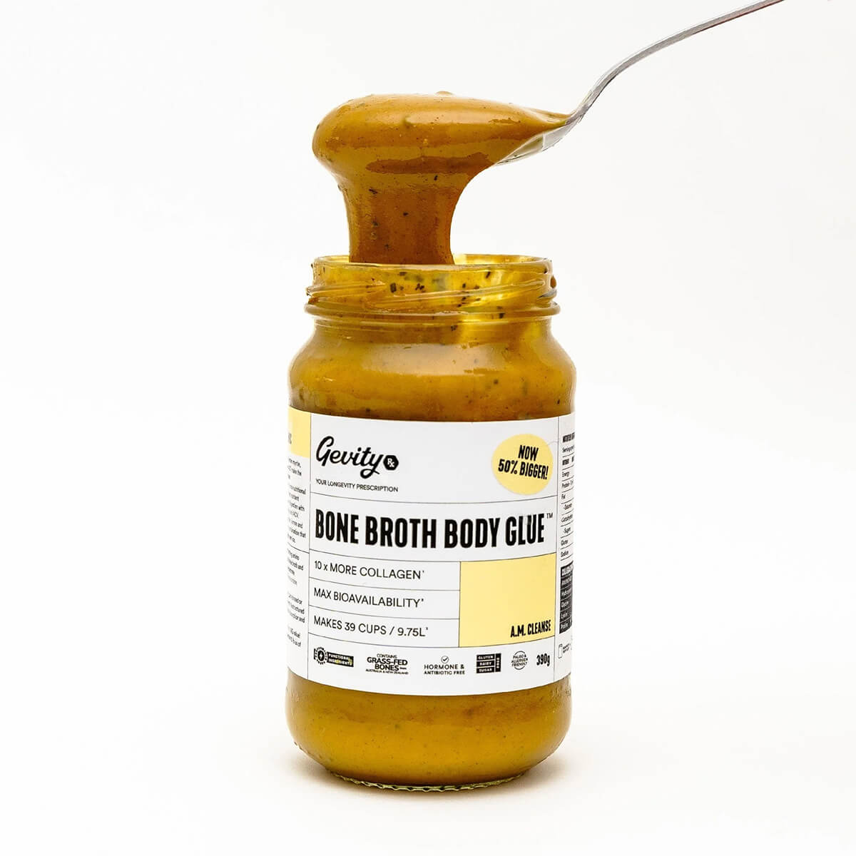 Jar of 'Bone Broth Body Glue' with a spoonful being lifted, on a white background.