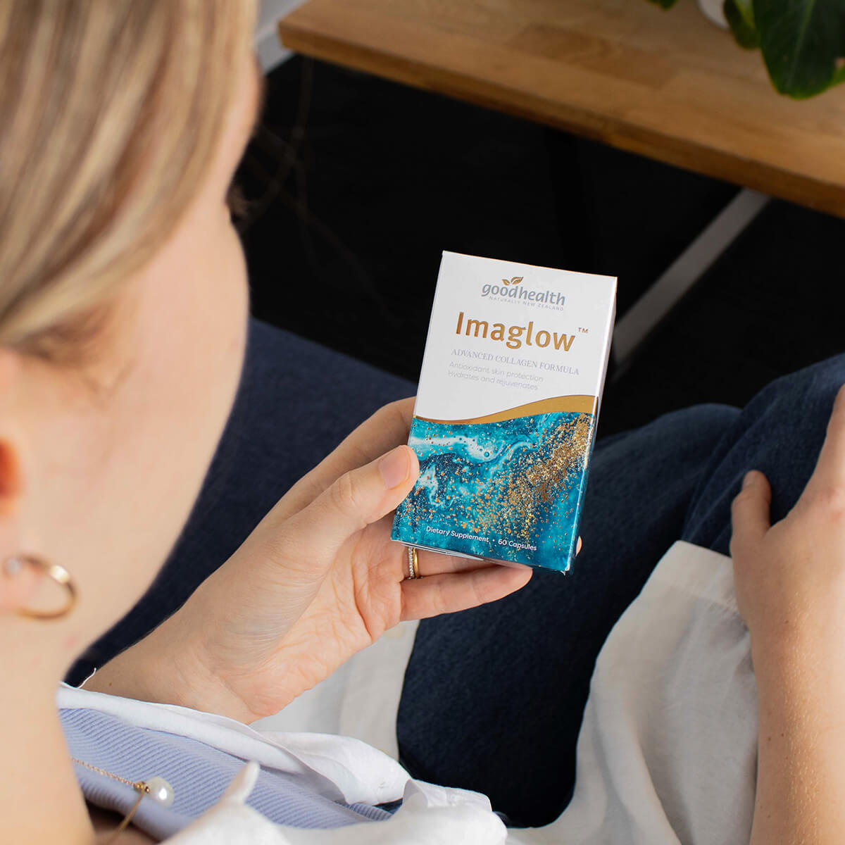 Person holding a 'goodhealth Imaglow' product packaging.