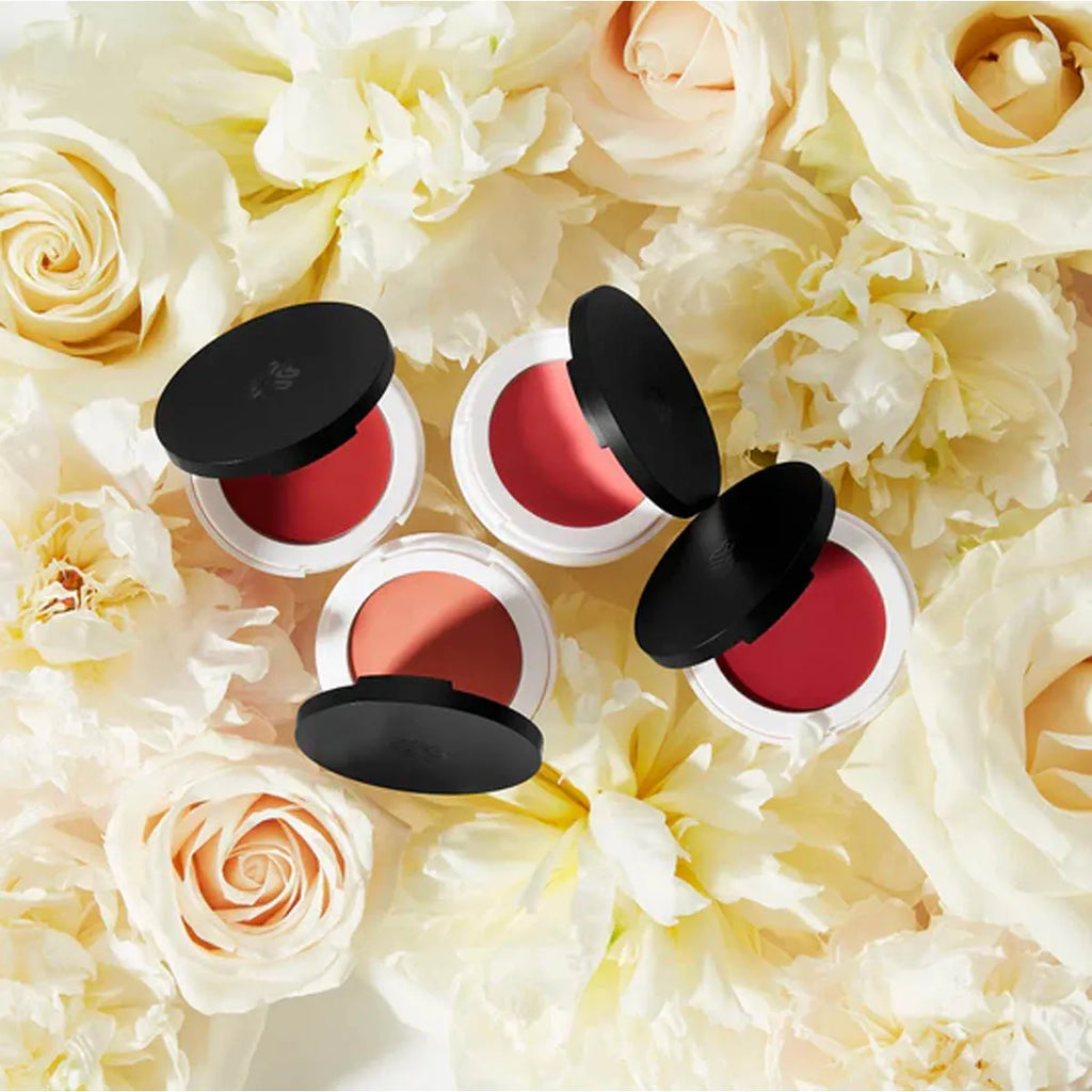 4 Lily Lolo Lip & Cheek Cream compact shades on a bed of white roses