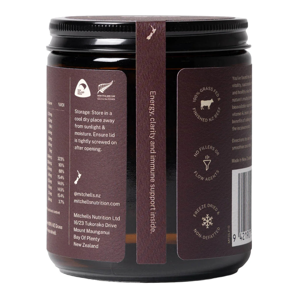 A dark brown jar of Mitchell Nutrition Turaxx with a black lid, showing the back and side labels with product information and icons.