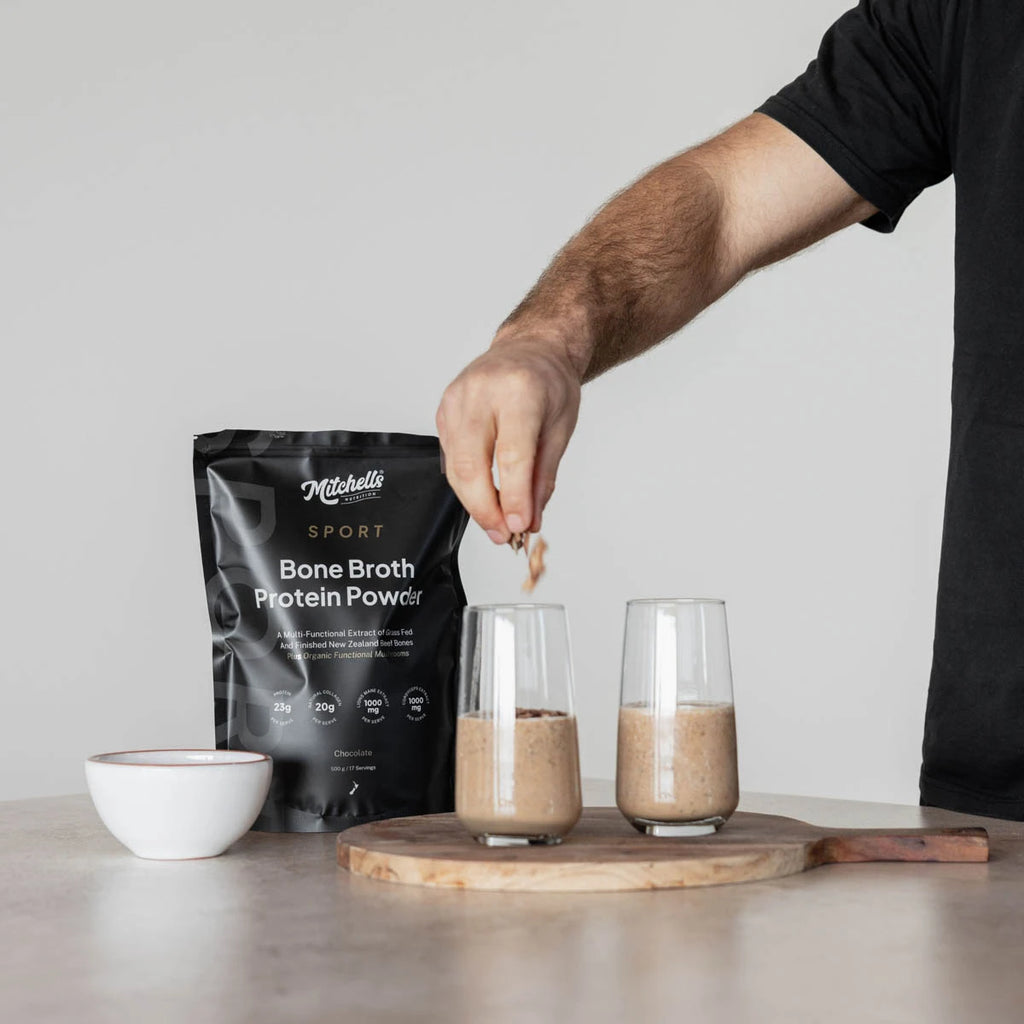 Person preparing a bone broth protein powder shake with a package of Mitchell's Sport Bone Broth Protein Powder.