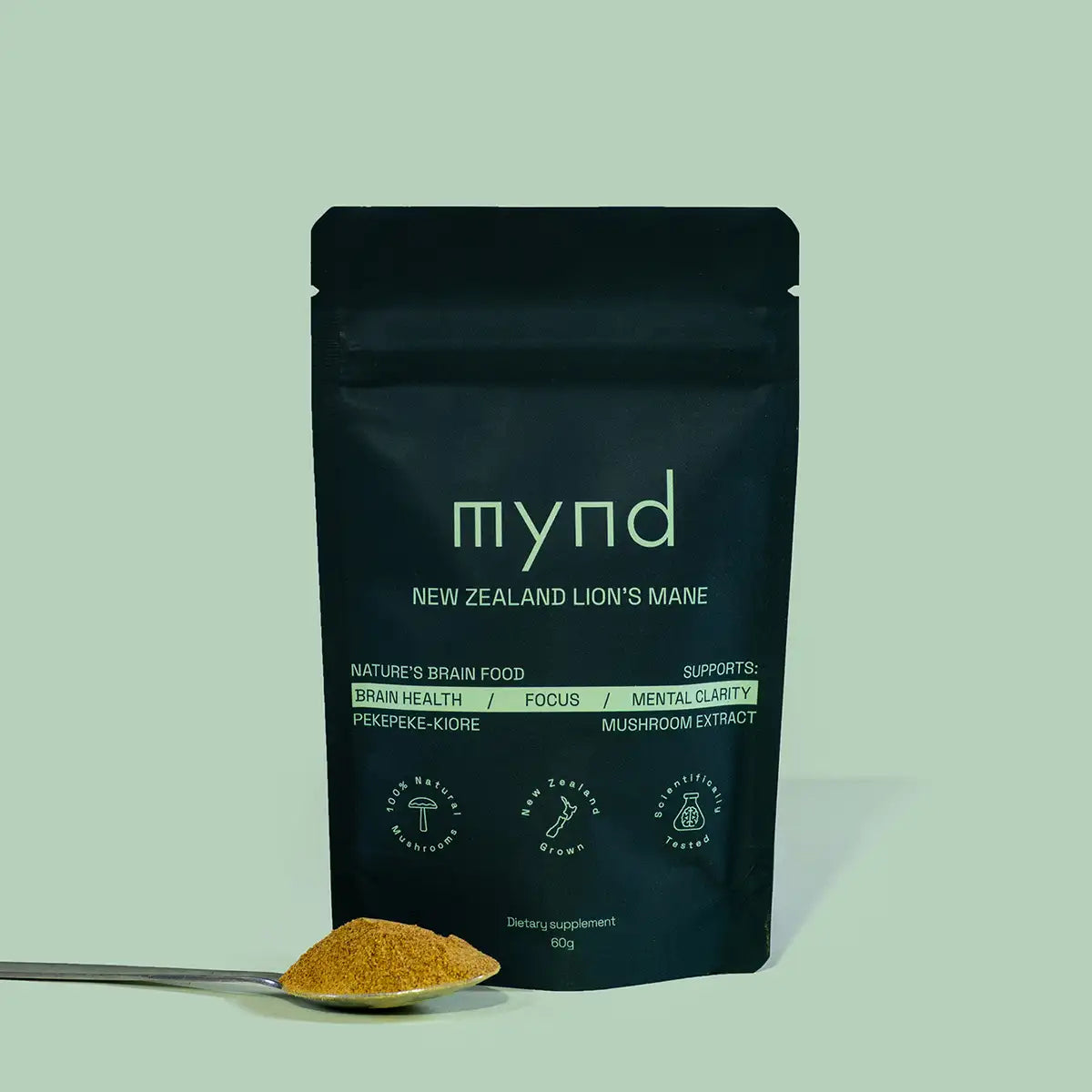 Black Mynd supplement package with lion's mane mushroom powder on a spoon against a light green background.