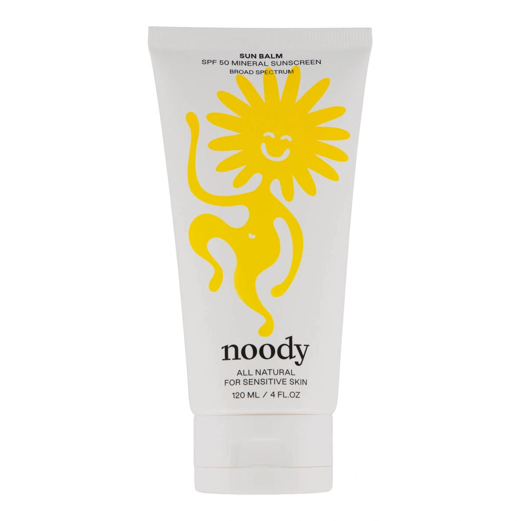 A white squeeze tube of Noody Sun Balm SPF50 Mineral Sunscreen Broad Spectrum, featuring a large yellow cartoon sun graphic and black text on a white background. Suitable for the whole family.