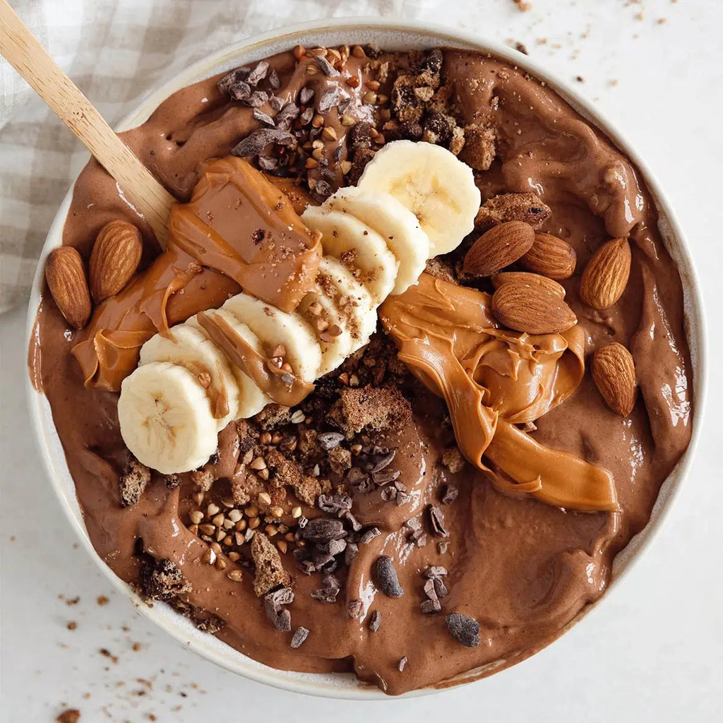 Smoothie bowl with chocolate banana peanut butter and granola. 