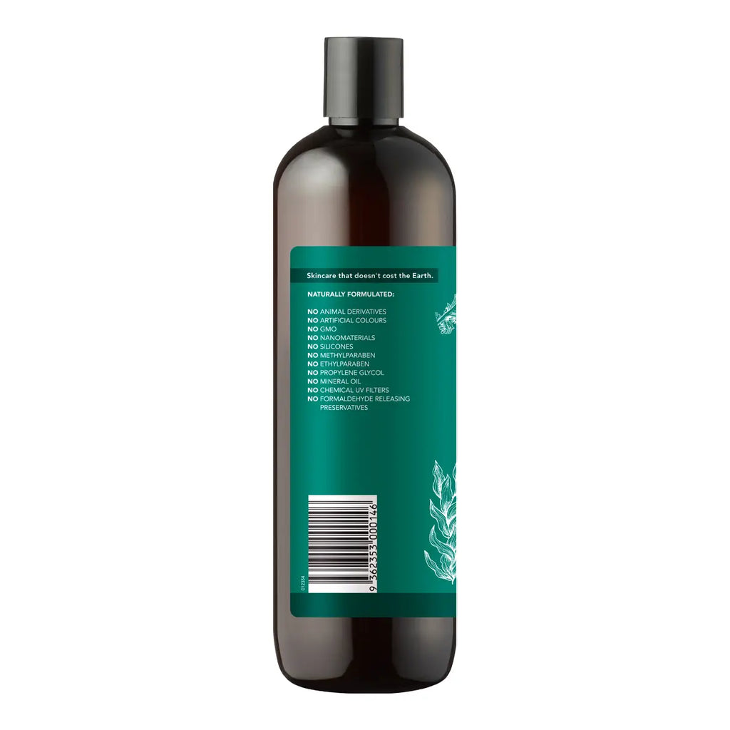A dark amber-brown bottle with a black cap and a green label, shown from the back on a plain white background.